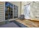 Outdoor patio area with wicker seating, a glass table, and a sliding glass door entrance at 8364 Chaceview Ct, Charlotte, NC 28269