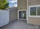 Back patio with siding door, white fence, and view of exterior of home at 961 Sardis Cove Dr, Charlotte, NC 28270