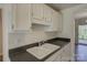 Kitchen featuring a double basin sink, updated countertops, and classic white cabinetry at 961 Sardis Cove Dr, Charlotte, NC 28270