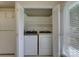 Laundry room with washer, dryer, shelving, and bi-fold doors at 961 Sardis Cove Dr, Charlotte, NC 28270
