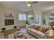 Bright living room with a white brick fireplace, neutral furniture, and sliding glass doors at 961 Sardis Cove Dr, Charlotte, NC 28270