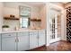 Elegant bar area with modern cabinets, wine racks, and stylish decor, perfect for entertaining at 1018 Heritage Pointe # 302, Indian Trail, NC 28079