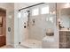 This bathroom boasts a large shower with elegant marble walls and a vanity with shaker cabinets at 1018 Heritage Pointe # 302, Indian Trail, NC 28079