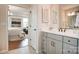 Bright bathroom featuring a vanity with shaker cabinets, neutral walls, and an open view to the bedroom at 1018 Heritage Pointe # 302, Indian Trail, NC 28079