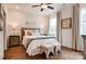 Charming bedroom featuring hardwood floors, a ceiling fan, bedside tables, and decorative art at 1018 Heritage Pointe # 302, Indian Trail, NC 28079