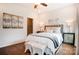 Cozy bedroom featuring hardwood floors, decorative art, bedside tables, and a walk-in closet at 1018 Heritage Pointe # 302, Indian Trail, NC 28079