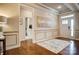Bright foyer featuring hardwood floors, decorative molding, and a view of the upstairs bathroom at 1018 Heritage Pointe # 302, Indian Trail, NC 28079