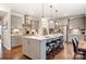 Spacious kitchen featuring an island with seating, pendant lighting, stainless steel appliances, and ample counter space at 1018 Heritage Pointe # 302, Indian Trail, NC 28079