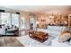 Open-concept living room with hardwood floors, stylish furnishings, and views into the dining and kitchen areas at 1018 Heritage Pointe # 302, Indian Trail, NC 28079