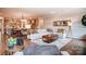 Bright living room boasts modern furnishings, an open floorplan, and is connected to the kitchen and dining area at 1018 Heritage Pointe # 302, Indian Trail, NC 28079