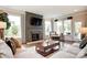 Bright living room featuring a stone fireplace, hardwood floors, comfortable seating, and ample natural light at 1018 Heritage Pointe # 302, Indian Trail, NC 28079