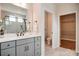 Main bathroom features double vanity, large mirror, and glass shower with white marble-styled tile at 1018 Heritage Pointe # 302, Indian Trail, NC 28079