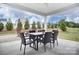 Outdoor patio area featuring a dining set under a covered space and relaxing views of the backyard at 1018 Heritage Pointe # 302, Indian Trail, NC 28079