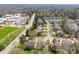 Aerial photograph of a neighborhood near a school and surrounded by lush trees and green landscape at 110 Kingsdown Ave, Charlotte, NC 28270