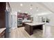 Bright kitchen featuring an island, stainless steel appliances, granite counters, and modern pendant lighting at 110 Kingsdown Ave, Charlotte, NC 28270