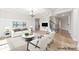 A staged living room showcases neutral tones, modern furniture, and an elegant chandelier at 110 Kingsdown Ave, Charlotte, NC 28270