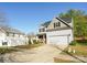 Inviting two-story home with a two-car garage and a well-manicured lawn at 11320 Joe Morrison Ln, Charlotte, NC 28214