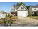 Charming two-story home featuring a two-car garage, brick accents, and a well-maintained front yard at 11320 Joe Morrison Ln, Charlotte, NC 28214