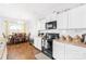 Bright kitchen with white cabinetry, stainless steel appliances, and an adjacent dining area with natural light at 11320 Joe Morrison Ln, Charlotte, NC 28214