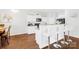 Bright kitchen boasts white cabinets, breakfast bar, and views to adjacent dining area at 11320 Joe Morrison Ln, Charlotte, NC 28214