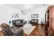 Inviting living room with plush seating, a decorative mirror, and warm wood floors at 11320 Joe Morrison Ln, Charlotte, NC 28214