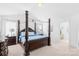 Spacious main bedroom features a four-poster bed, vaulted ceiling, and ensuite access at 11320 Joe Morrison Ln, Charlotte, NC 28214