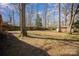 Lush backyard featuring mature trees and a mix of open space with partial fencing at 116 S Westover Dr, Monroe, NC 28112