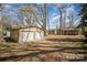 Spacious backyard featuring a two-car garage with ample room for vehicles or storage at 116 S Westover Dr, Monroe, NC 28112
