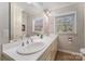 Bright bathroom featuring a dual sink vanity, large mirror, and good natural light at 116 S Westover Dr, Monroe, NC 28112