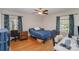 Bedroom with hardwood flooring, ceiling fan, and natural light at 116 S Westover Dr, Monroe, NC 28112