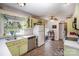Functional kitchen featuring classic appliances, bright green cabinetry, and ample natural light at 116 S Westover Dr, Monroe, NC 28112