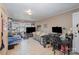 Bright living room featuring a couch, two large monitors and neutral tile flooring at 116 S Westover Dr, Monroe, NC 28112