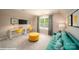Spacious bonus room with a yellow sofa and desk space at 121 Asmodean Ln, Troutman, NC 28166
