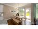 Cozy dining area with a wooden table, bench seating, and natural light from the patio door at 121 Asmodean Ln, Troutman, NC 28166