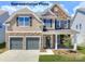 Charming two-story home featuring a two-car garage and a welcoming front porch at 121 Asmodean Ln, Troutman, NC 28166