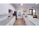 Community kitchen with white cabinets and appliances, granite countertops, and stainless steel sink at 121 Asmodean Ln, Troutman, NC 28166