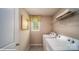 Efficient laundry room with washer, dryer, storage shelves, and natural light from the window at 121 Asmodean Ln, Troutman, NC 28166
