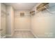 This is a walk-in closet with white wire shelving and neutral walls and carpet at 121 Asmodean Ln, Troutman, NC 28166