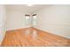 A bedroom with hardwood floors, chair railing and natural light from the windows at 126 Harbourtown Dr, Kings Mountain, NC 28086