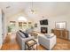 Stylishly furnished living room with fireplace, modern furniture, and beautiful hardwood floors at 126 Harbourtown Dr, Kings Mountain, NC 28086