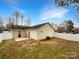 Backyard with a small patio area, privacy fence, and lawn space for relaxation at 1313 Ridgewood Dr, Concord, NC 28027