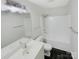 Well-lit bathroom with a sleek vanity, modern fixtures, and a shower-tub combination at 1313 Ridgewood Dr, Concord, NC 28027