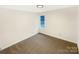 Simple bedroom with carpet, white walls, and a small window offering natural light at 1313 Ridgewood Dr, Concord, NC 28027