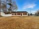 Inviting single-story home featuring red shutters and a well-maintained front lawn at 1313 Ridgewood Dr, Concord, NC 28027