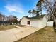 Detached garage with an extra long driveway, green roof and clean, neutral design at 1313 Ridgewood Dr, Concord, NC 28027