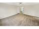 Spacious living room with a ceiling fan and light neutral walls and carpet at 1313 Ridgewood Dr, Concord, NC 28027