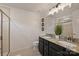Bathroom with dual vanities, granite counters, a glass shower, and modern fixtures at 1317 Queen Lyon Ct, Charlotte, NC 28205