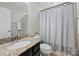 Bathroom featuring granite counters, dark wood cabinetry, and a shower with a curtain at 1317 Queen Lyon Ct, Charlotte, NC 28205