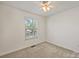 The bedroom features a ceiling fan, neutral carpet, and a bright window at 1317 Queen Lyon Ct, Charlotte, NC 28205
