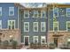 Charming townhome featuring a blue exterior, brick accents, and well-maintained landscaping at 1317 Queen Lyon Ct, Charlotte, NC 28205